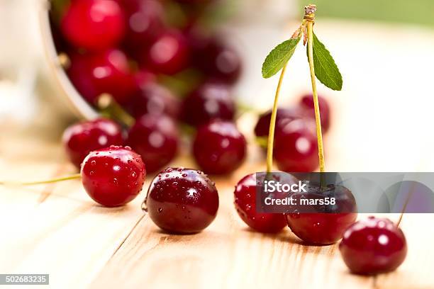 Cherries On Wooden Table With Water Drops Macro Background Stock Photo - Download Image Now