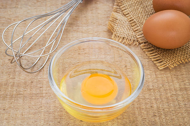 istock Fresh egg in bowl and metal whisk 502683987