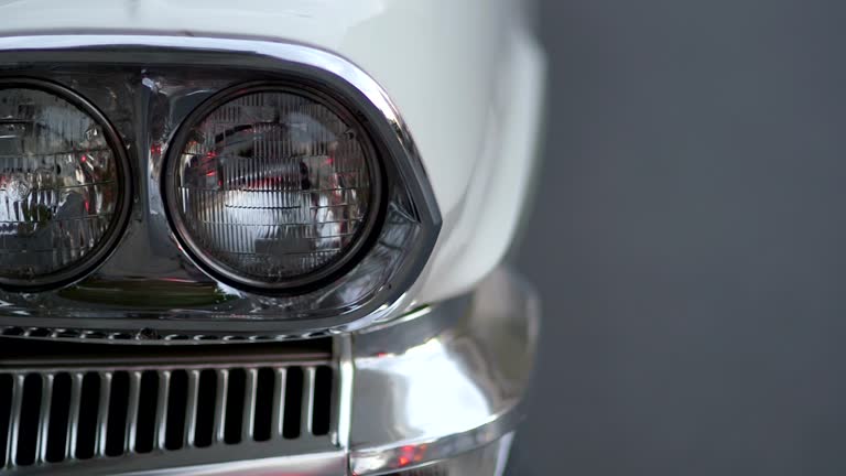 CLOSE UP PANNING Headlights of white vintage car