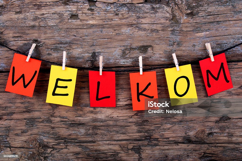 Welkom on Notes Hanging on a Line The Dutch Word Welkom, which means Welcome, on Notes Hanging on a Line on Wooden Background Celebration Stock Photo