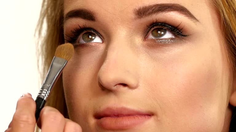 Beauty Girl with Makeup Brush. close up. Slow motion