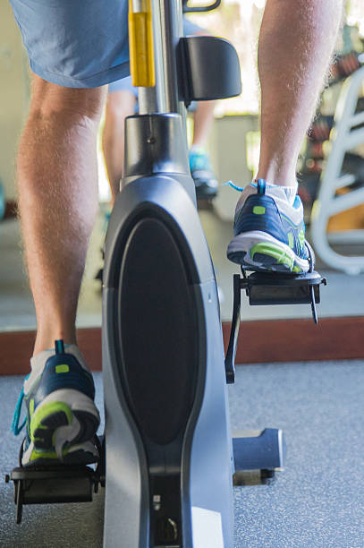 istock Man feet exercising indoor bicycle 502696004