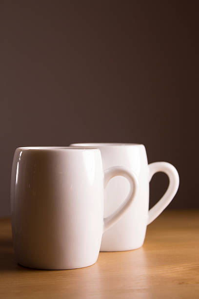 istock Two white coffee cup on wooden table. 502696234
