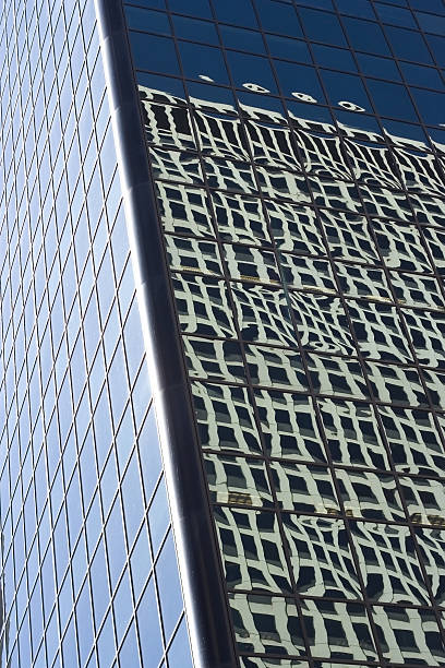 reflection of building in windows stock photo