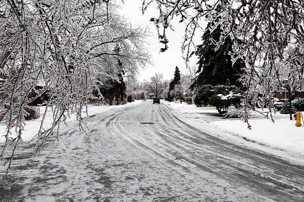 Toronto, Canada  - December 22, 2013: An ice covered street with ice encassed trees along the way, all the result of the ice storm of December 21, 2013 in Toronto, Canada.