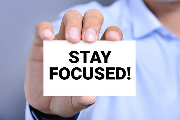 istock STAY FOCUSED! message on the card shown by a man 502702202