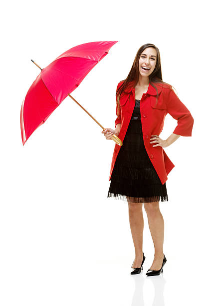 istock Cheerful woman holding umbrella & looking at camera 502703907