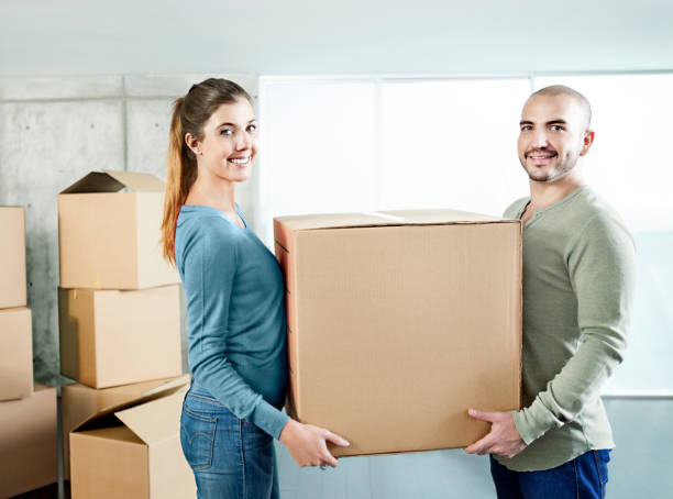 istock Couple carrying cardboard boxes 502703973