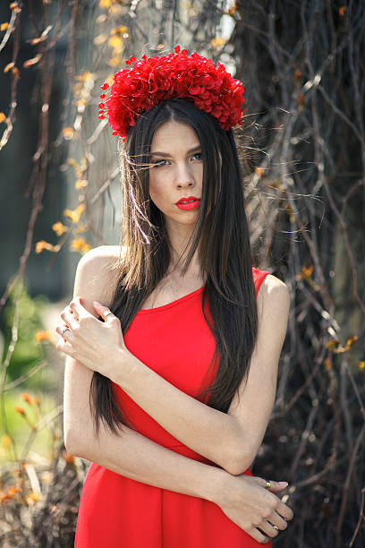 istock Young pretty girl is posing with flowers 502704107