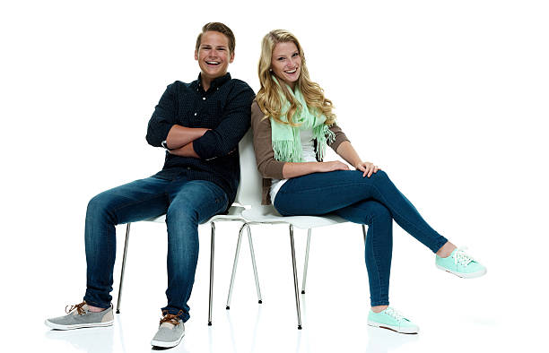 istock Cheerful couple sitting on chair & looking at camera 502704215
