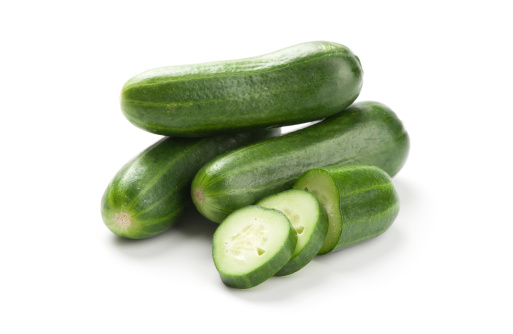 Cucumber and slices isolated over white background