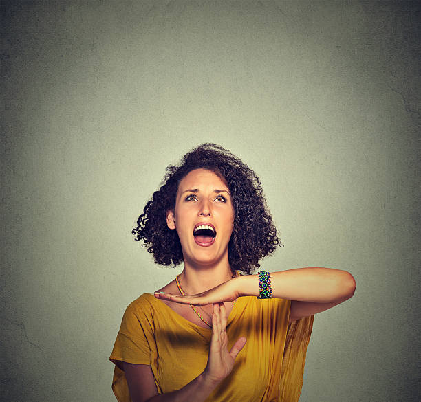 Woman showing time out hand gesture, frustrated screaming Young woman showing time out hand gesture, frustrated screaming to stop isolated on grey wall background. Too many things to do. Human emotions face expression reaction time out signal stock pictures, royalty-free photos & images