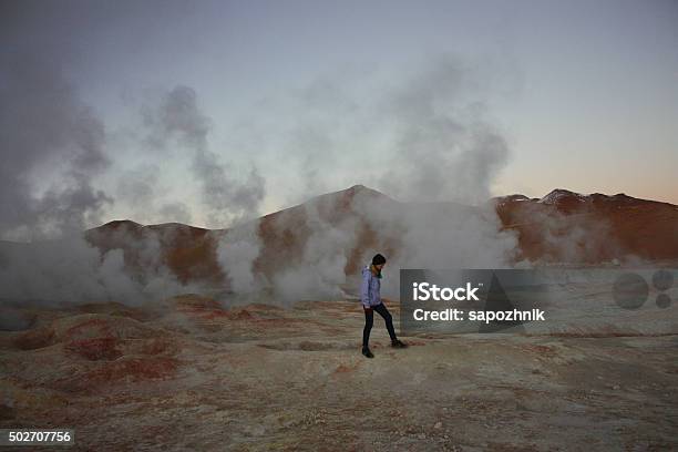 Female Walking On Geyser And Fumaroles Bolivia Stock Photo - Download Image Now - 2015, Activity, Adult