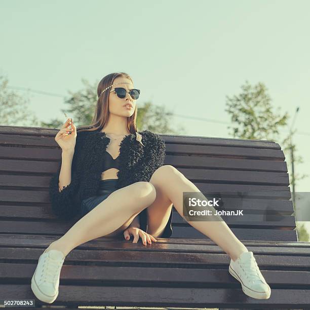 Young Woman Smoke In Park Stock Photo - Download Image Now - Adult, Adults Only, Autumn