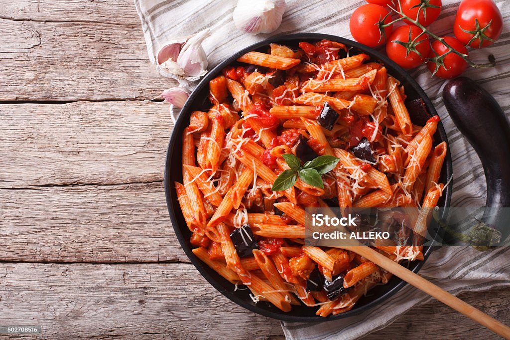 Italian Pasta alla Norma close-up and ingredients. horizontal to Italian food: Pasta alla Norma close-up on the table and ingredients. horizontal top view Pasta Stock Photo