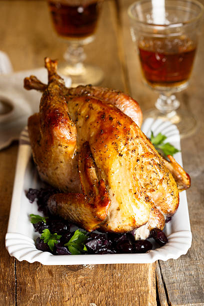 Baked guinea fowl Baked guinea fowl with wine and grape sauce guinea fowl stock pictures, royalty-free photos & images