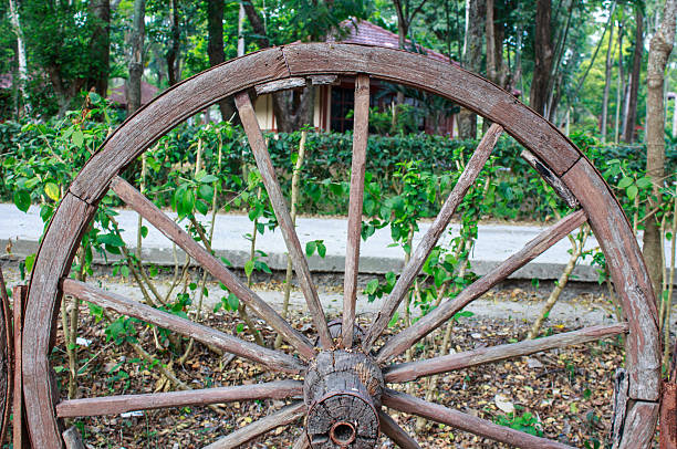 istock wooden wagon wheel in garden 502724236