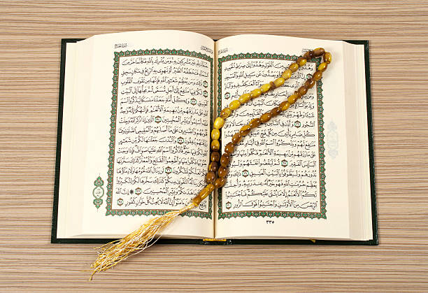 istock Holy Quran with prayer beads on table 502724401