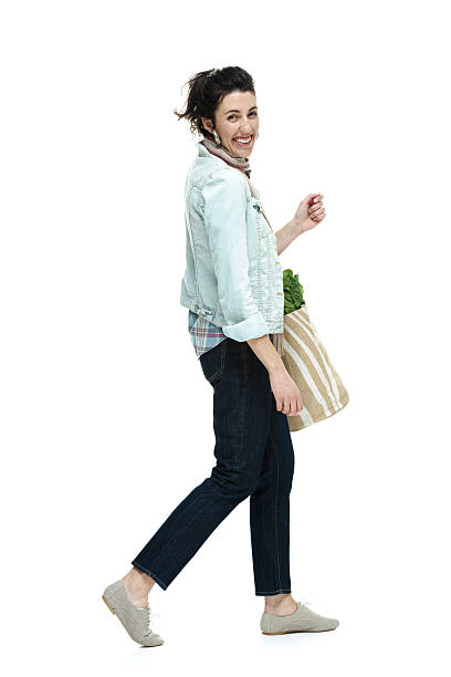 istock Cheerful woman walking & looking at camera 502724541