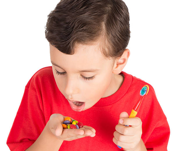 istock Young boy with candies and teeth brush 502724712
