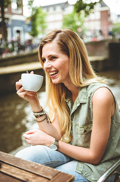 istock Woman holding a coffee cup in amsterdam 502725345