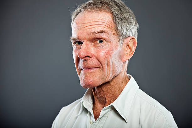 istock Expressive characteristic senior man against grey wall. 502725557