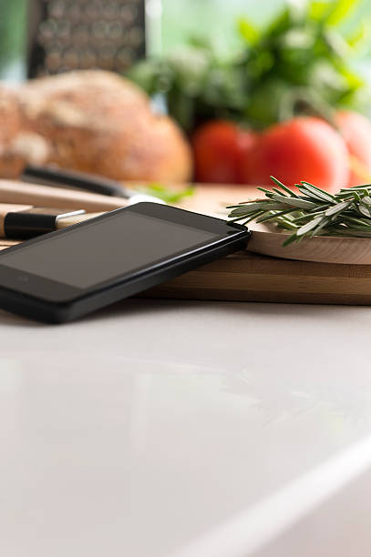 istock Cooking with a mobile phone in kitchen 502725759