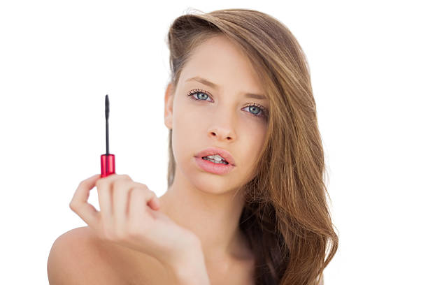 istock Serious brunette model holding a mascara tube 502727407