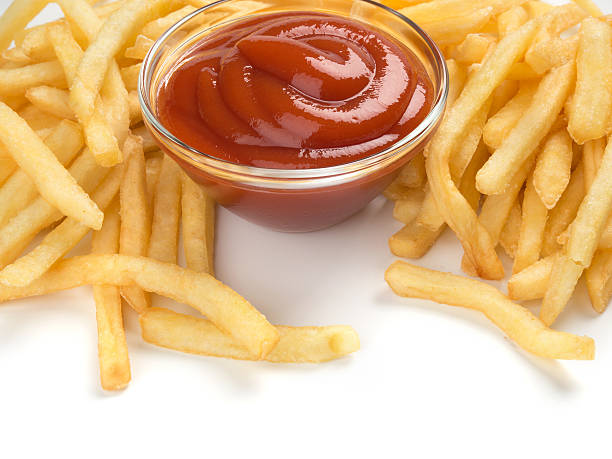 istock French fries with ketchup on white 502728363