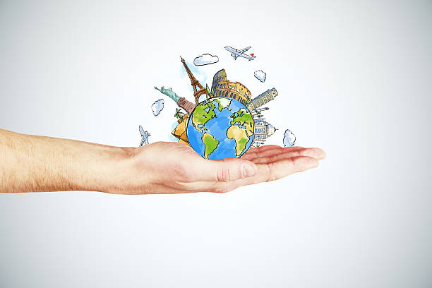 istock Travel concept with man hand and round earth with landmarks 502730196