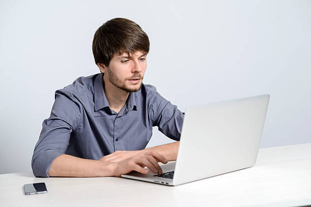 istock Young man working at laptop 502730374