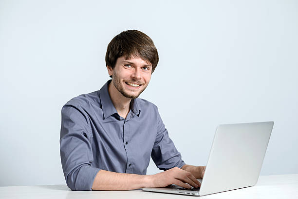 istock Happy smiling young man watching and working on laptop 502730870