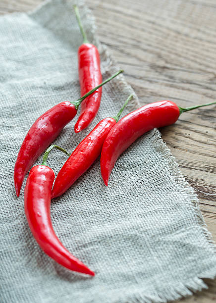 istock Stack of fresh red chili peppers on the burlap 502733012