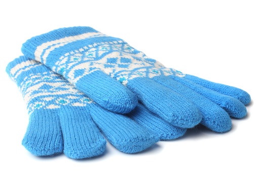 Warm woolen knitted gloves on white background