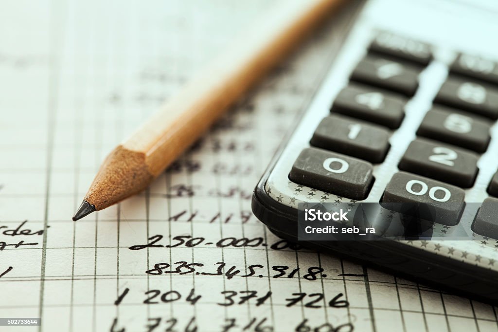 Calculator and pencil Calculator Stock Photo