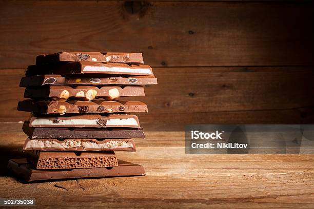 Chocolate Stack On Wooden Background Stock Photo - Download Image Now - Chocolate, 2015, Backgrounds