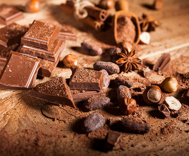 istock Chocolate pieces on wooden background 502735318