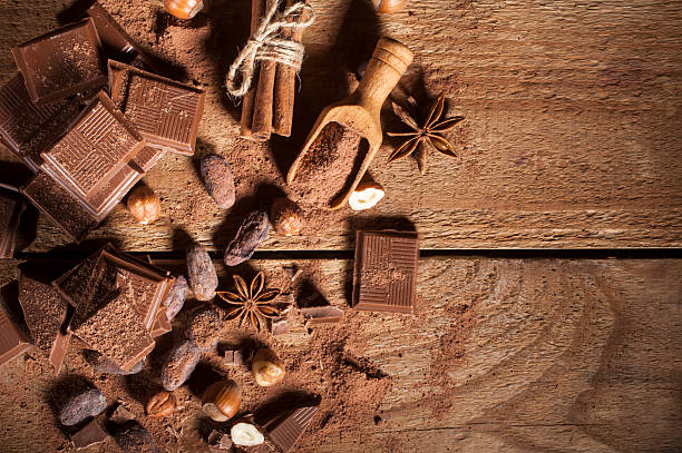 istock Chocolate pieces on wooden background 502735374