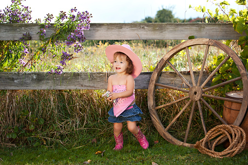 Adorable toddler dressed as a cowgirl.
