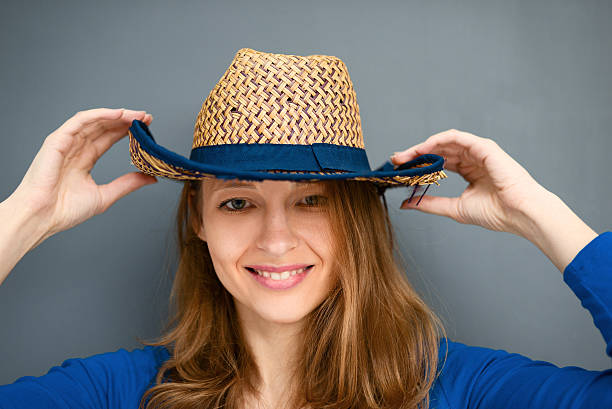 istock Young woman posing with a hat on a gray background 502738738