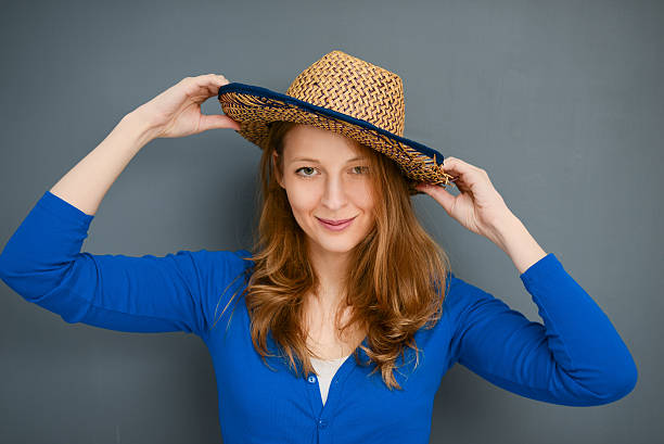 istock Young woman posing with a hat on a gray background 502738748