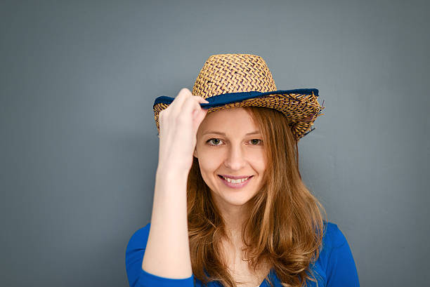 istock Young woman posing with a hat on a gray background 502738768
