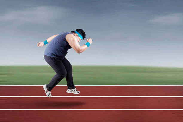 istock Fat man running on track 502738961