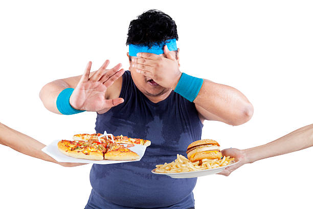 istock Fat man rejecting junk food 502739007