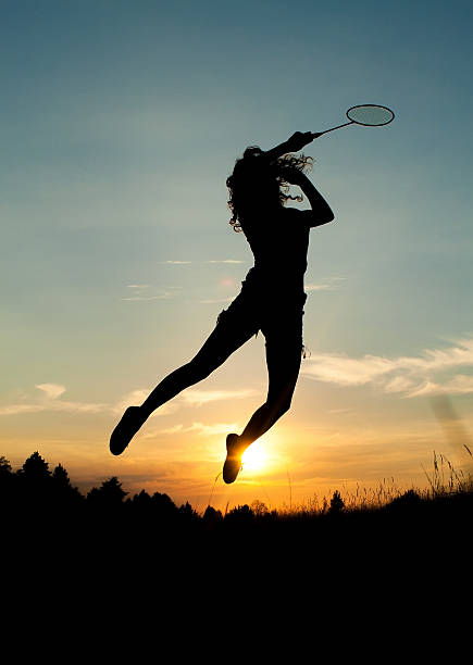 istock Jumping Girl Playing Badminton 502739394