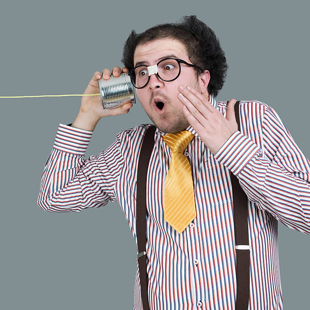 istock Nerd male listening through a tin can phone 502740433