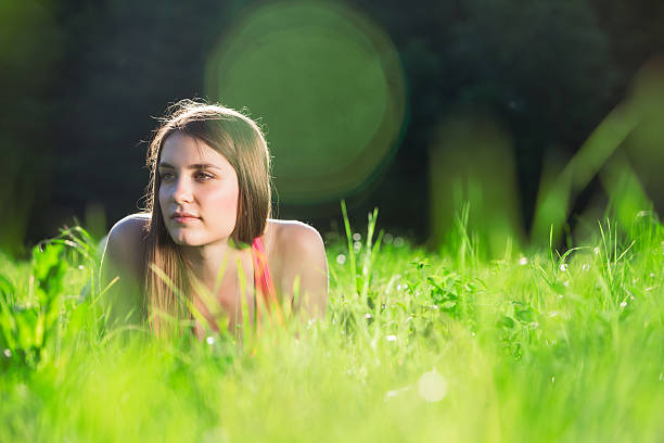 Beautiful young woman doing yoga exercises in the park stock photo