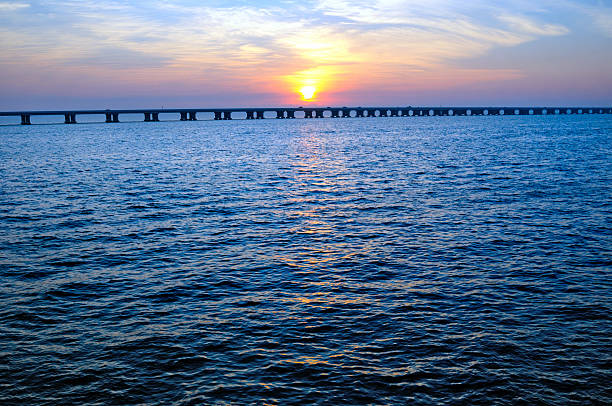 The sun rising over the Gulf of Mexico showing the Sunshine Skyway Bridge in Tampa, Florida