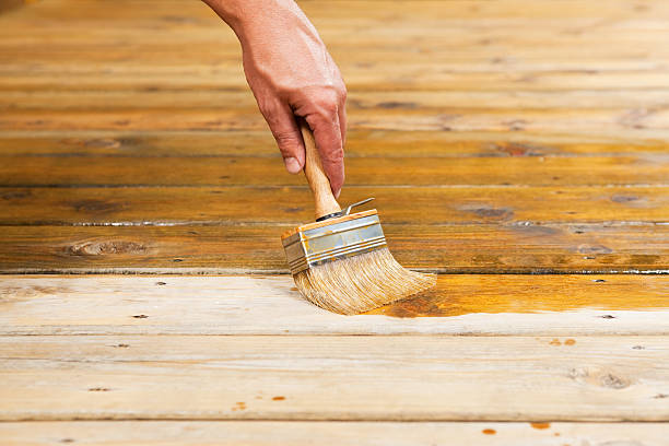 istock Hand Applying Deck Stain with a Large Paintbrush 502744393
