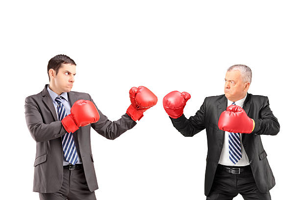 istock Two businessmen having a fight with boxing gloves 502745415